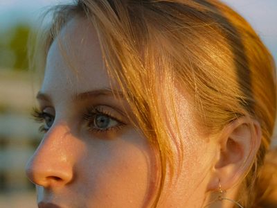 Close-up of a calm eye reflecting a serene landscape.